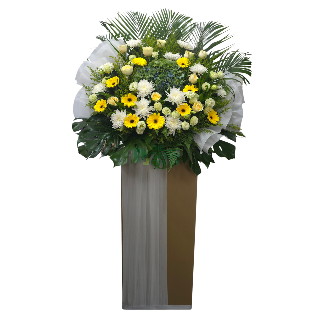 Aura de Fleurs condolence wreath in white and gold with yellow gerbera and buttercup roses on a tall stand — The Green Corner Singapore