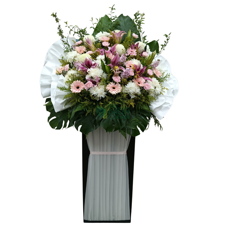 Noble Remembrance condolence wreath in soft pink and white with lilies, gerbera and purple stock on a tall stand — The Green Corner Singapore