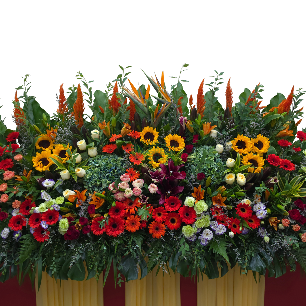 Close-up of the Prosperity Spire grand opening stand showing sunflowers, red gerbera, bird of paradise and orange celosia